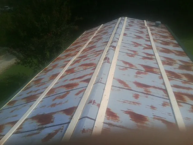 Rusted metal roof panels with new wood purlins before replacement — Storm Damage Roof Repair in Mazomanie by Roofing Brothers